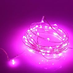 a purple light with some white lights on it's end and one wire is plugged into the ground