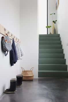 an instagram page with stairs and clothes hanging on the wall