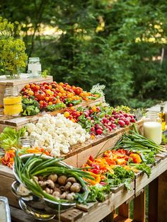 an assortment of fresh vegetables on display at a farmer's market table with milk and juice