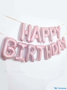 two pink balloons that say happy birthday hanging from a string on a white wall,