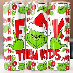 the grin face is on top of two green cans with red and white lettering that says,