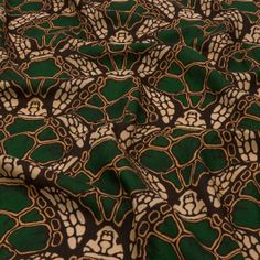 a green and black fabric with gold designs on it