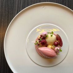 a white plate topped with food on top of a wooden table