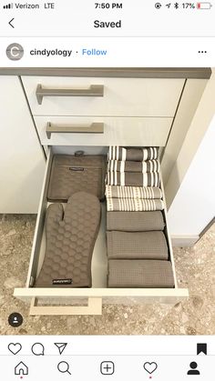 an open drawer with towels in it