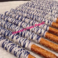 several chocolate covered donuts are lined up on a table with white and blue icing