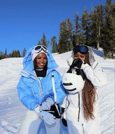 two women in ski gear posing for the camera