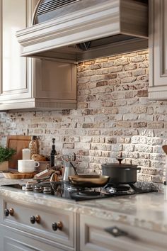 a stove top oven sitting inside of a kitchen next to a counter with pots and pans on it