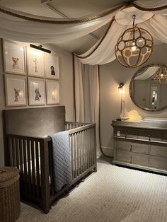 a baby's room with a crib, dresser and mirror on the wall