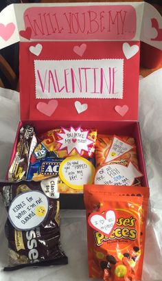 an open valentine's day box filled with candy