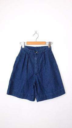 "Vintage High Waisted Denim Shorts/Pleated Denim Shorts. Measurements Total Length  : 19\" Waist              : 22\" Hips                : 36\" Inseam           :  7 \" Rise                 : 13\" Condition      : Gently used. There`s no stains or holes. Good condition. ※Please read the policy before you purchase※" Medium Wash Wide Leg Cotton Jean Shorts, Medium Wash Wide Leg Jean Shorts, Wide Leg Medium Wash Cotton Jean Shorts, High Waist Medium Wash Cotton Bermuda Shorts, Retro Dark Wash Jean Shorts For Spring, Dark Wash High Waist Cotton Shorts, High Waist Denim Blue Bermuda Shorts, High-waisted Denim Bermuda Shorts In Blue, Retro Dark Wash Cotton Shorts