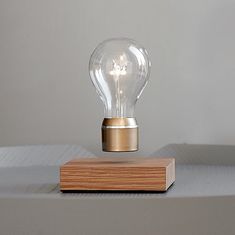 a light bulb sitting on top of a wooden block