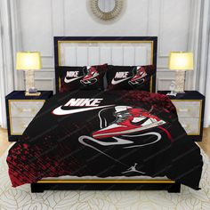 a bed with black and red comforters in a bedroom