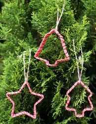 three red and white stars hanging from a tree