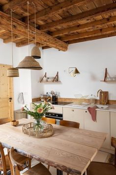 a wooden table sitting in the middle of a kitchen