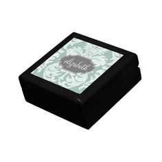 a black box with a green and white damask pattern