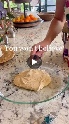 a person is making bread on a glass plate