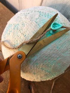 a pair of scissors is being used to trim a hat