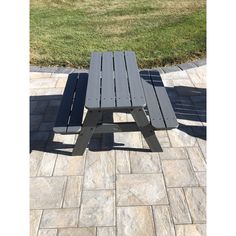 a picnic table sitting on top of a stone patio