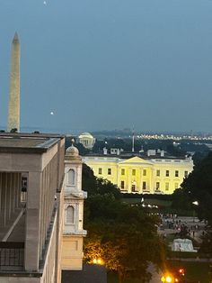 the washington monument is lit up at night in front of the white house and capitol building