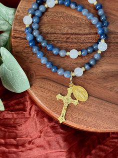 Discover our exquisite Blue Rosary with a unique touch - a movable Mother Mary and Crucifix, designed to make your prayer experience more convenient and versatile. Crafted with care and devotion, this rosary is more than just a piece of jewelry; it's a symbol of your faith and a constant companion on your spiritual journey. 🙏 Pause and Pray: With the movable Mother Mary and Crucifix, you can pause your prayers at any time and easily pick up where you left off. Whether you're interrupted or wish to focus on one mystery at a time, this rosary makes it effortless to continue your devotions. 🌟 All-Day Wear: Wear your blue rosary bracelet throughout the day as a constant reminder of your faith and a source of strength. It's not only a beautiful accessory but also a meaningful tool for your sp Adjustable Rosary Bracelet For Healing With 108 Beads, Blue Stackable Wrap Bracelet As Gift, Spiritual Rosary Bracelet With 108 Beads, Adjustable Spiritual Rosary Bracelet With 108 Beads, Blue Spiritual Wrap Bracelet As Gift, Blue Spiritual Style Wrap Bracelet As Gift, Blue Rosary Bracelet Gift, Spiritual Rosary Bracelet As Gift, Blue Spiritual Wrap Bracelet With Gemstone Beads