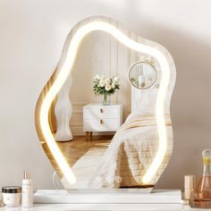 an illuminated mirror on top of a dresser