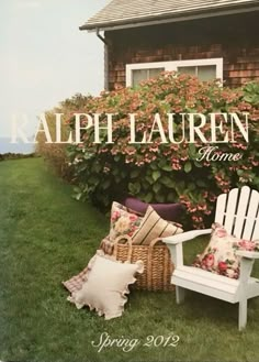 a magazine cover with two white chairs in front of a house and flowers on the lawn