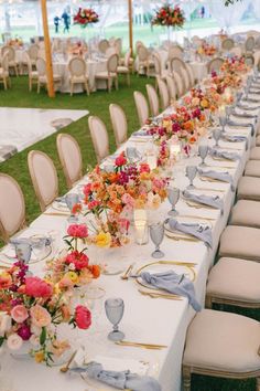 a long table is set up with flowers and place settings