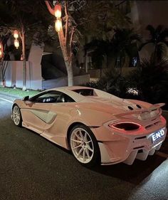 a white sports car parked on the street at night