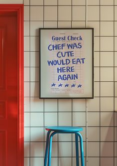 a blue stool sitting in front of a sign on the wall next to a red door