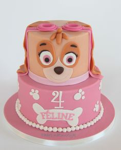 a pink cake with a dog on it's face and the number twenty four