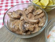 two bowls filled with mushrooms next to sliced bananas