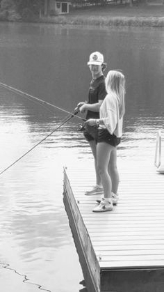 black and white photograph of two children fishing