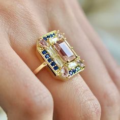 The Sapphire Morganite 1930s Cocktail ring features lab created Morganite, Sapphire & White Topaz gemstones on a vintage rectangle setting. Art deco inspired, she makes a statement with a mix of fancy gemstone cuts; baguettes, pear cut, emerald cut. The setting is comfortable, low profile and sits flush to the finger. Get ready for compliments! Lab Created Gemstones: Morganite, Sapphire & White Topaz Metal: 14k Gold Vermeil (Sterling Silver base) Dimensions: 18mm x 15mm Band Width: 1.8mm Hypoall Lab Grown Gemstone Ring, Rectangle Cocktail Ring, Art Deco Square Ring, Art Deco Gemstone Ring, Gemstone Cocktail Rings, Diamond Ring Settings Unique, Vintage Art Deco Ring, Fun Engagement Rings, Art Deco Ring Engagement