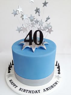 a blue birthday cake with silver stars and the number forty on it's top