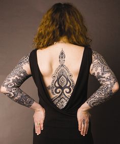 a woman with tattoos on her back