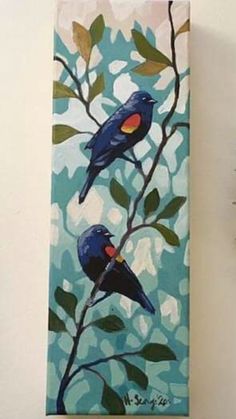 two blue birds perched on a tree branch