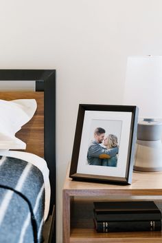 an image of a man and woman in love on a nightstand next to a bed