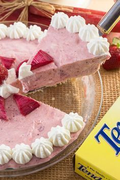 a strawberry cream pie with a slice missing from it