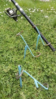 two fishing rods laying in the grass next to each other