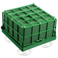 a green plastic crate sitting on top of wheels