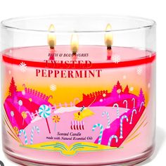 a pink candle that is inside of a glass container with candles in it and the words peppermint on top