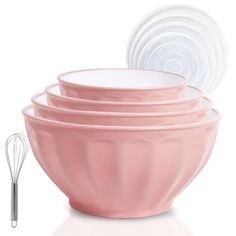 a stack of pink mixing bowls with whisk attachments next to each other