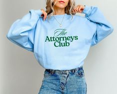 Lawyer Sweatshirt / Light Blue Attorneys Club Sweatshirt / Classy Oversized Lawyer Shirt A sturdy and warm sweatshirt bound to keep you warm in the colder months. A pre-shrunk, classic fit sweater that's made with air-jet spun yarn for a soft feel. * 50% cotton, 50% polyester * Pre-shrunk * Classic fit * 1x1 athletic rib knit collar with spandex * Air-jet spun yarn with a soft feel * Double-needle stitched collar, shoulders, armholes, cuffs, and hem This product is made especially for you as soo Lawyer Sweatshirt, Chic Sweatshirt, Womens Hoodies, Nurse Sweatshirt, Club Sweatshirts, Sport Chic, Sporty Chic, Fitted Sweater, Nurse Gifts