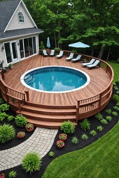 an above ground pool surrounded by landscaping and decking with lounge chairs on the side