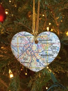 a heart shaped ornament hanging from a christmas tree