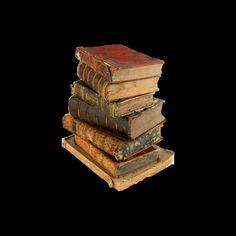 a stack of old books sitting on top of each other