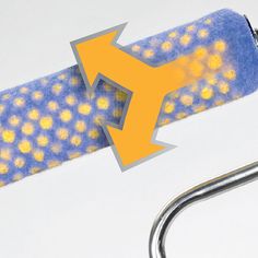 a close up of a pair of scissors with yellow dots on it and an arrow pointing to the right