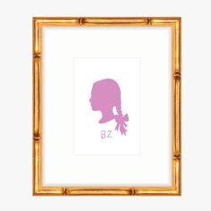 the silhouette of a woman's head in pink against a white background with gold frame