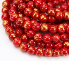 red beads with gold speckles on them