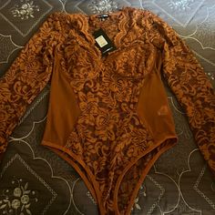 Fashion Nova Lace Bodysuit Size Xl In The Color Rust. Orange Stretch One-piece Bodysuit, Fitted Orange V-neck Bodysuit, Stretch Orange One-piece Bodysuit, Orange Fitted One-piece Bodysuit, Fitted Orange One-piece Bodysuit, Spring Party Brown Bodysuit, Orange Party Bodysuit For Spring, Orange One-piece Bodysuit For Spring, Spring Orange One-piece Bodysuit